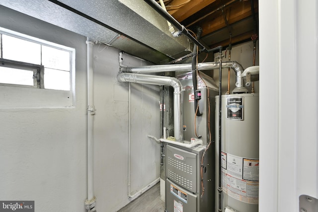 utility room featuring gas water heater