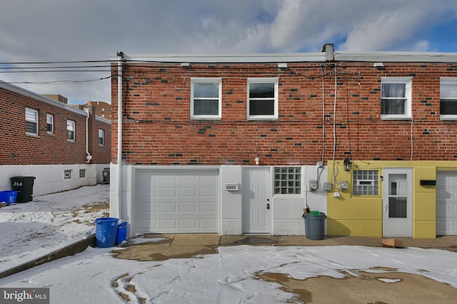 view of property featuring brick siding and an attached garage