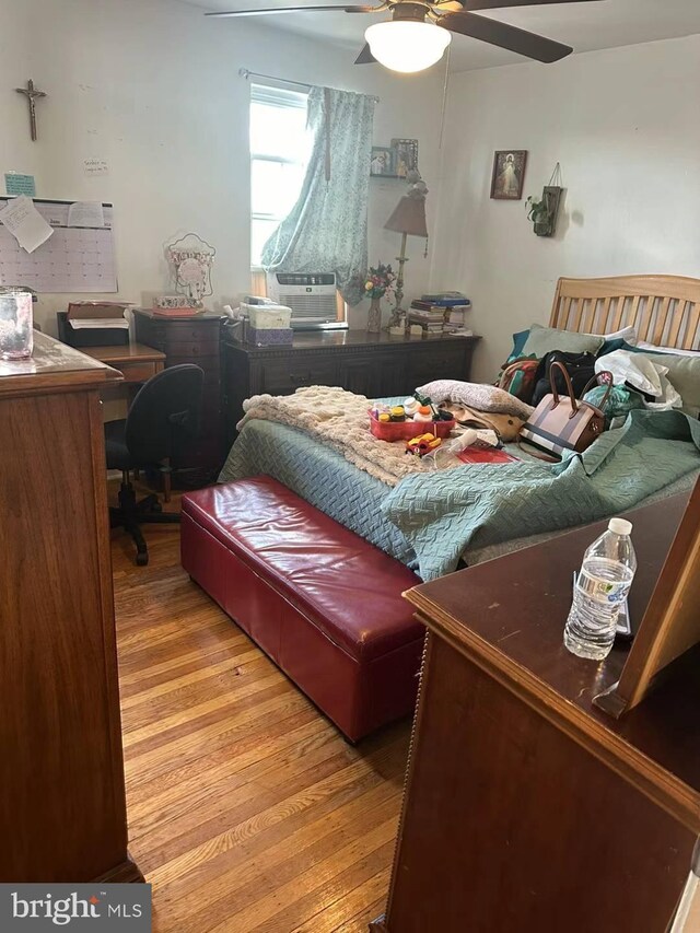 bedroom with hardwood / wood-style floors and ceiling fan