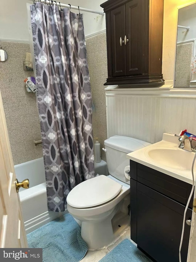 full bathroom with vanity, toilet, and shower / bath combo with shower curtain