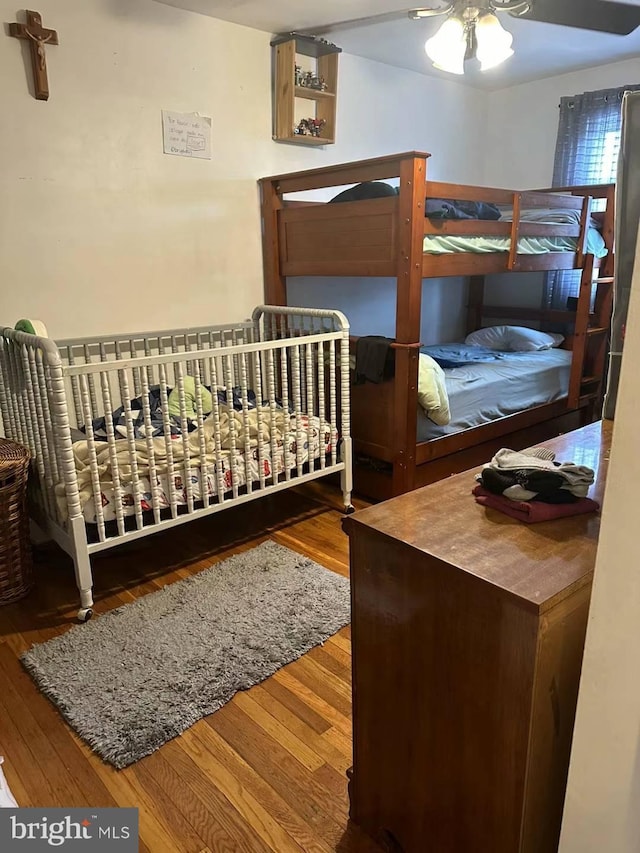 bedroom with hardwood / wood-style flooring and ceiling fan