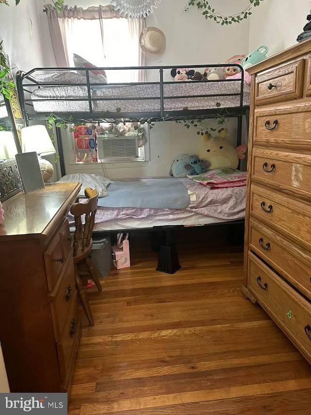 bedroom featuring cooling unit and wood-type flooring