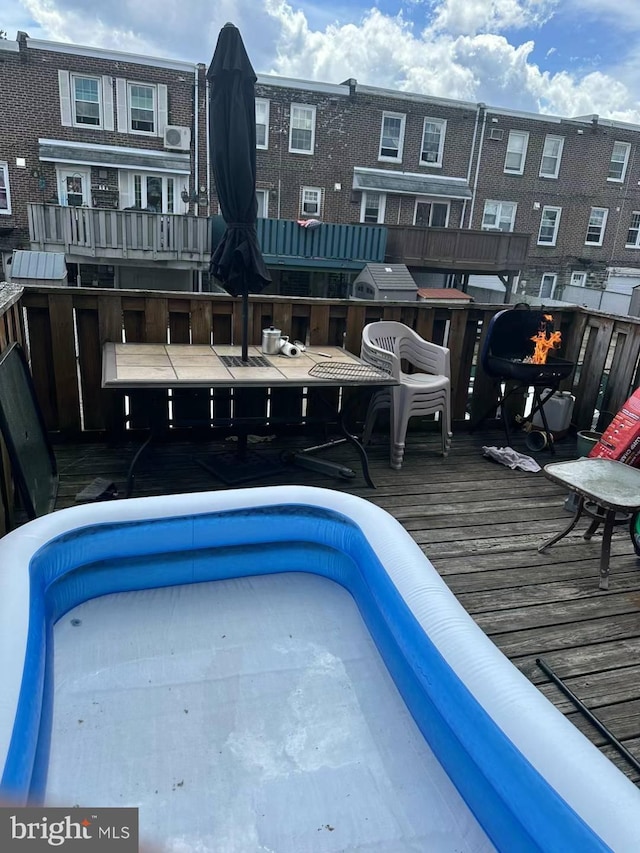 view of swimming pool featuring a wooden deck