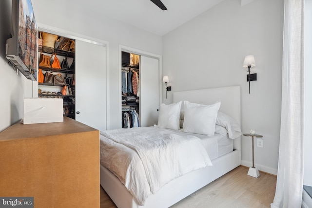 bedroom featuring a closet, baseboards, and wood finished floors