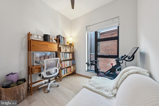 home office with wood finished floors, a ceiling fan, and baseboards