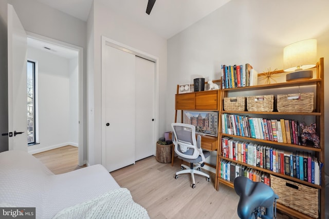 bedroom with a closet, visible vents, and wood finished floors