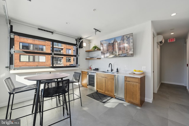 bar featuring baseboards, wine cooler, a sink, an AC wall unit, and stainless steel dishwasher