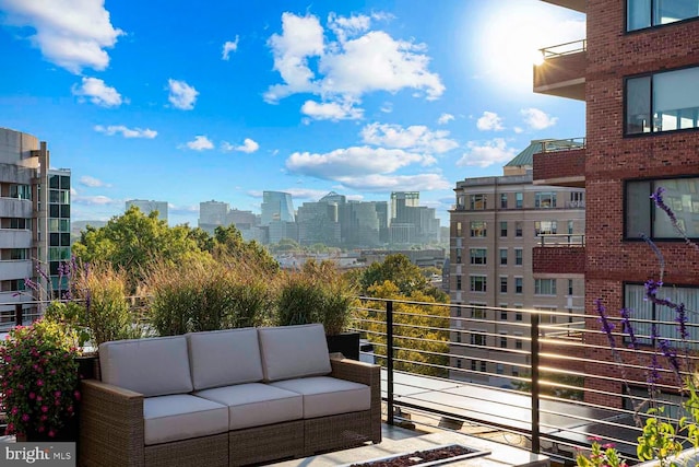 balcony with a view of city and an outdoor hangout area