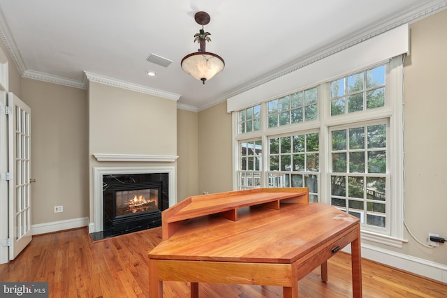 dining room featuring crown molding and light wood-type flooring