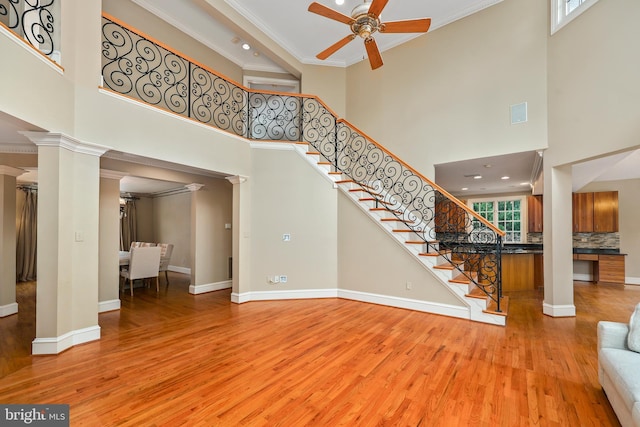 unfurnished living room featuring a towering ceiling and decorative columns