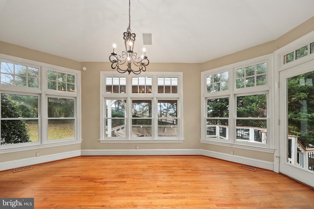 unfurnished sunroom with a chandelier