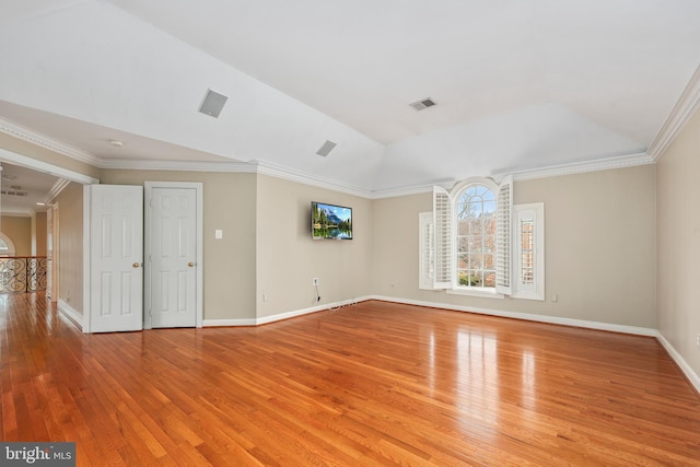 spare room with crown molding, lofted ceiling, and light hardwood / wood-style floors