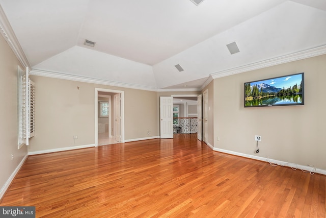 unfurnished living room with crown molding, vaulted ceiling, and wood-type flooring