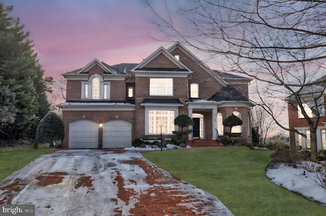 view of front of property with a garage and a lawn