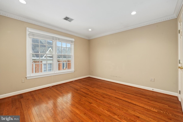 unfurnished room featuring hardwood / wood-style flooring and ornamental molding