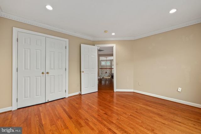 unfurnished bedroom featuring hardwood / wood-style flooring and ornamental molding