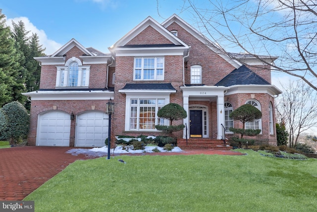 view of front of home with a garage and a front lawn