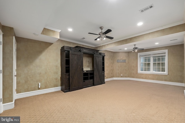 unfurnished living room featuring crown molding, carpet floors, and ceiling fan