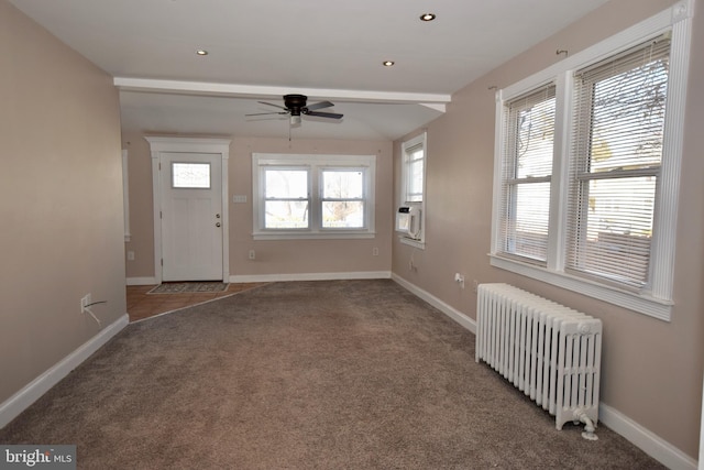 entrance foyer featuring carpet flooring, radiator heating unit, ceiling fan, and cooling unit