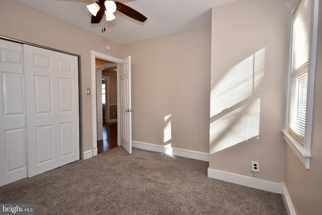 unfurnished bedroom with carpet floors, a closet, and ceiling fan