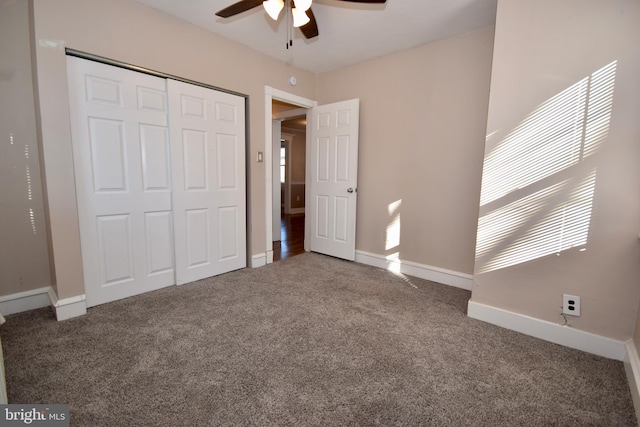 unfurnished bedroom with carpet flooring, ceiling fan, and a closet