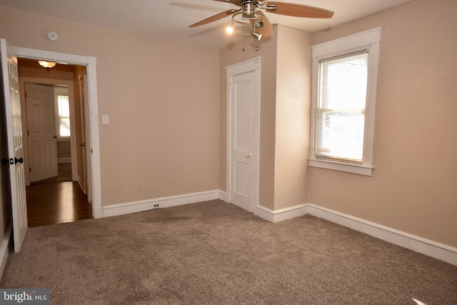 unfurnished bedroom featuring ceiling fan and carpet