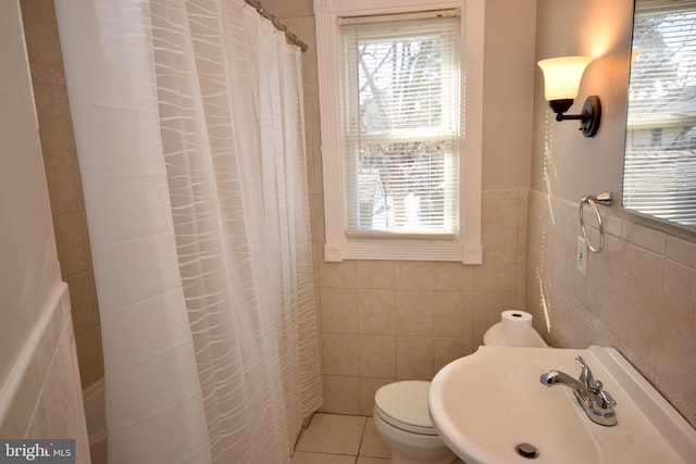 bathroom featuring walk in shower, sink, tile walls, tile patterned flooring, and toilet