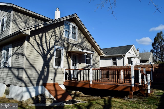 back of house with a deck