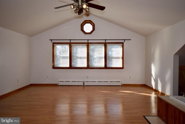 interior space with ceiling fan, a baseboard radiator, lofted ceiling, and wood-type flooring