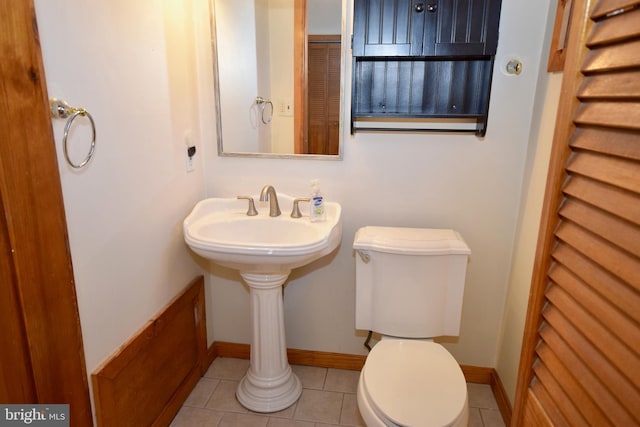 bathroom with tile patterned flooring and toilet