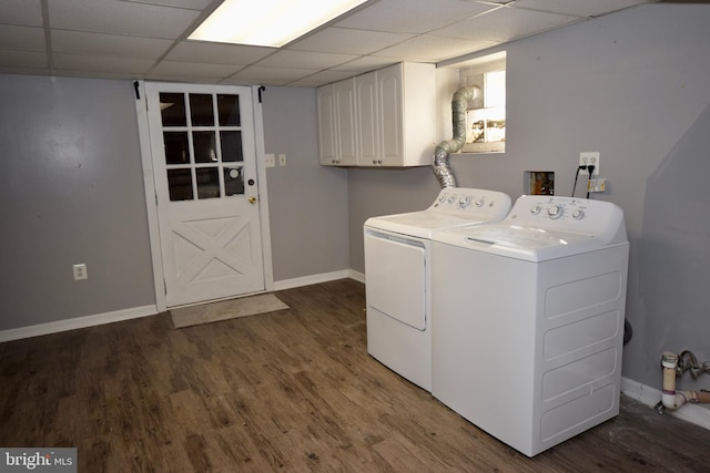 laundry area with cabinets, dark hardwood / wood-style flooring, and washing machine and dryer