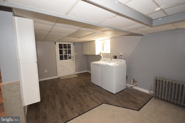 laundry area featuring washing machine and dryer, radiator heating unit, cabinets, and dark hardwood / wood-style floors