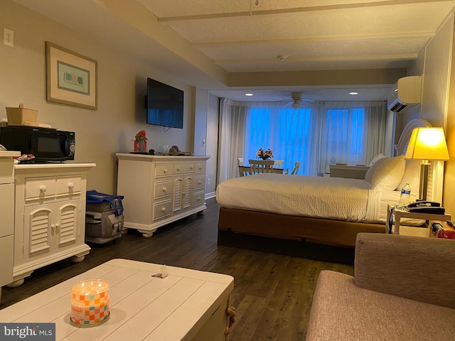 bedroom featuring dark hardwood / wood-style flooring and a wall mounted AC