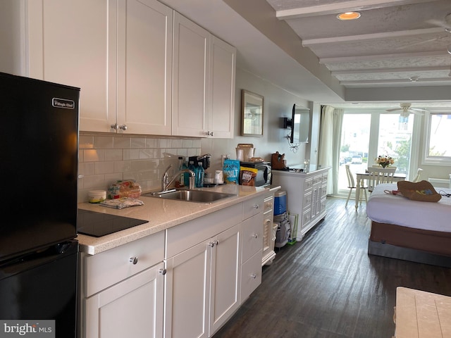 kitchen with black appliances, white cabinets, dark hardwood / wood-style floors, ceiling fan, and tasteful backsplash