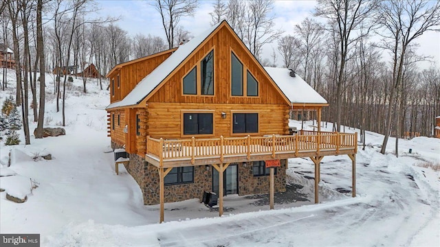 snow covered property featuring a wooden deck