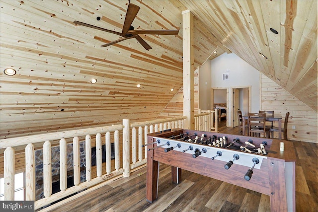 game room featuring wood-type flooring, wooden walls, vaulted ceiling, ceiling fan, and wooden ceiling