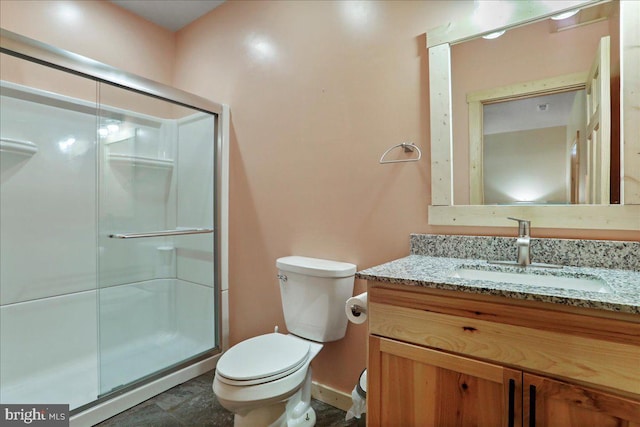 bathroom featuring toilet, an enclosed shower, and vanity