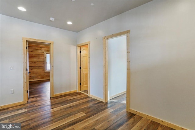 spare room with dark wood-type flooring