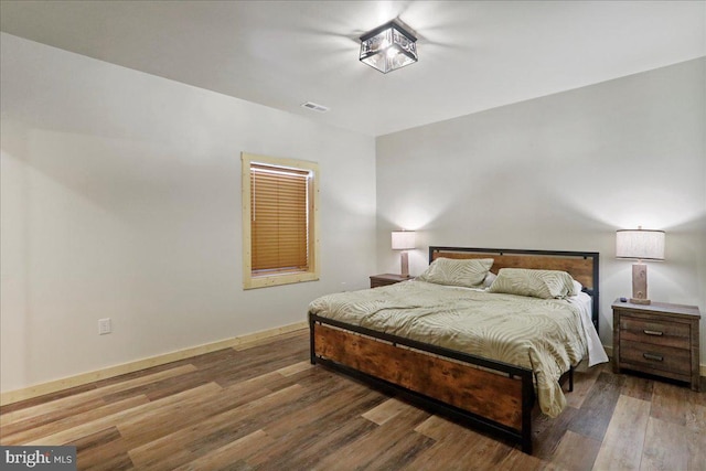 bedroom featuring dark hardwood / wood-style flooring