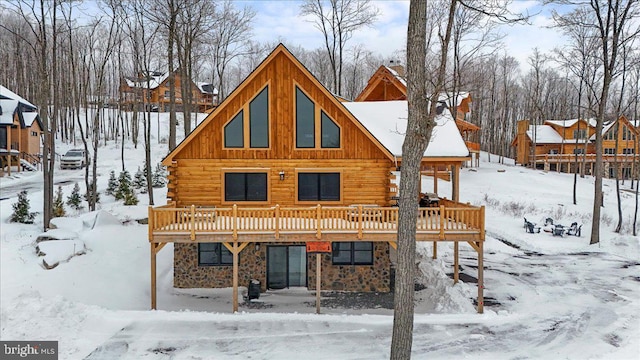 snow covered property featuring a wooden deck