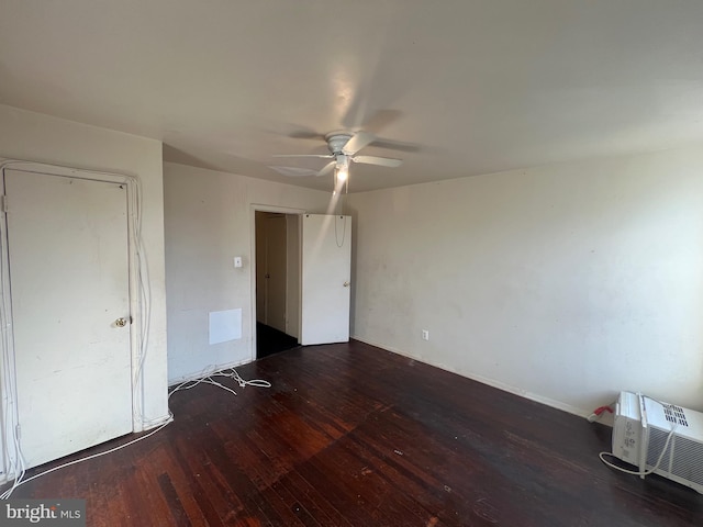 unfurnished bedroom featuring ceiling fan and dark hardwood / wood-style flooring