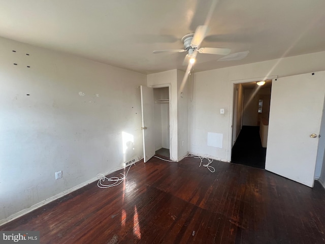 empty room featuring dark hardwood / wood-style flooring and ceiling fan