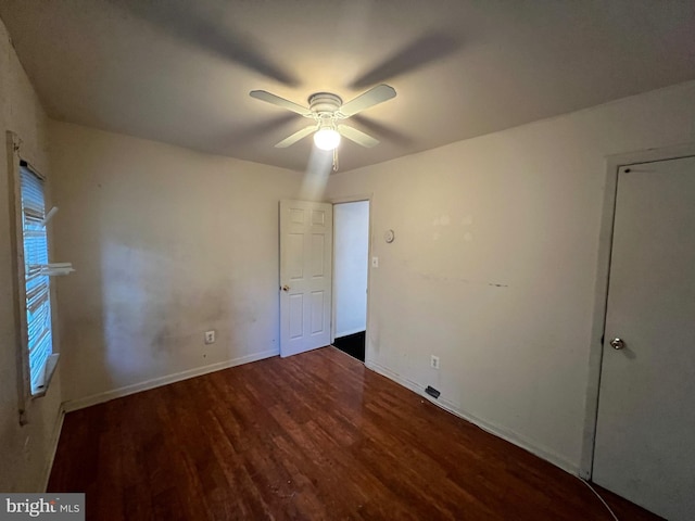 unfurnished bedroom featuring ceiling fan and dark hardwood / wood-style flooring