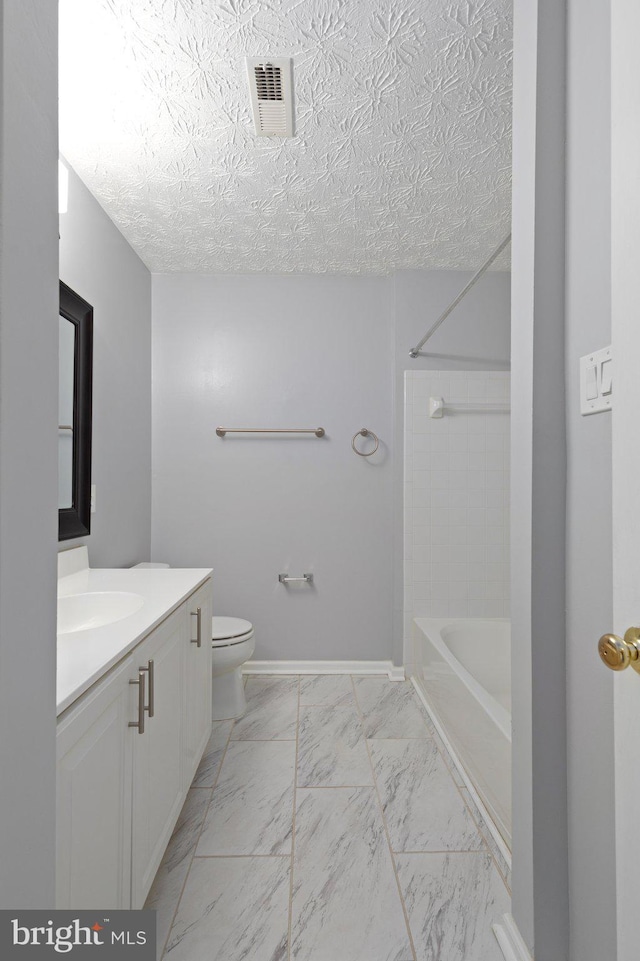 bathroom with toilet, a textured ceiling, and vanity