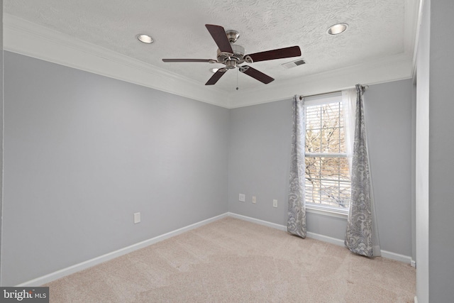 carpeted spare room featuring a textured ceiling, ceiling fan, and crown molding