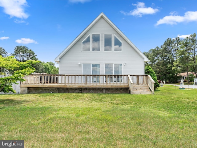 rear view of property featuring a yard and a wooden deck