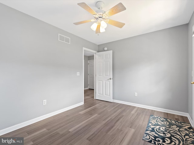 unfurnished bedroom featuring ceiling fan and hardwood / wood-style flooring