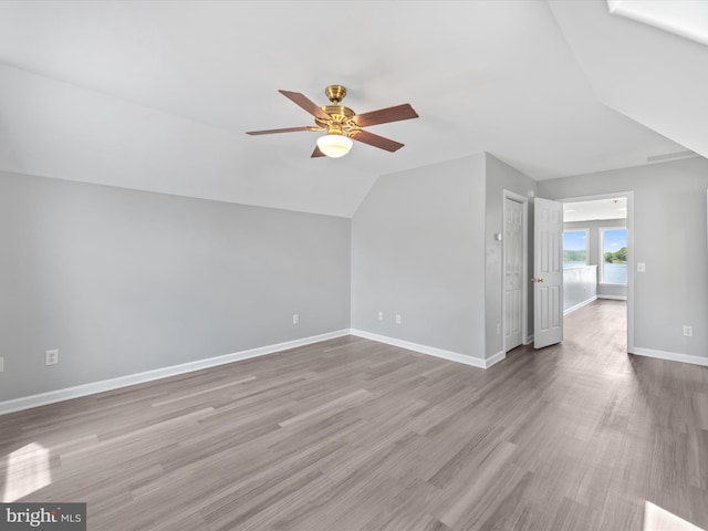 additional living space featuring ceiling fan, light wood-type flooring, and lofted ceiling