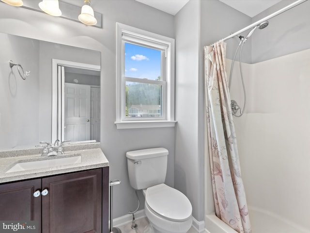 bathroom with vanity, toilet, and curtained shower