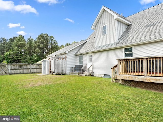 back of house with a yard, central AC, and a wooden deck